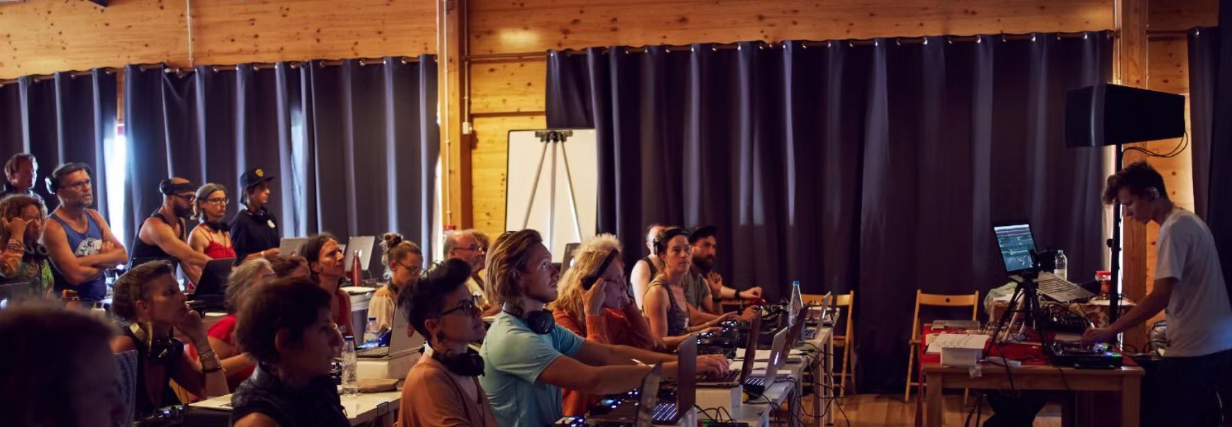A hands-on DJ training session with students at their controllers